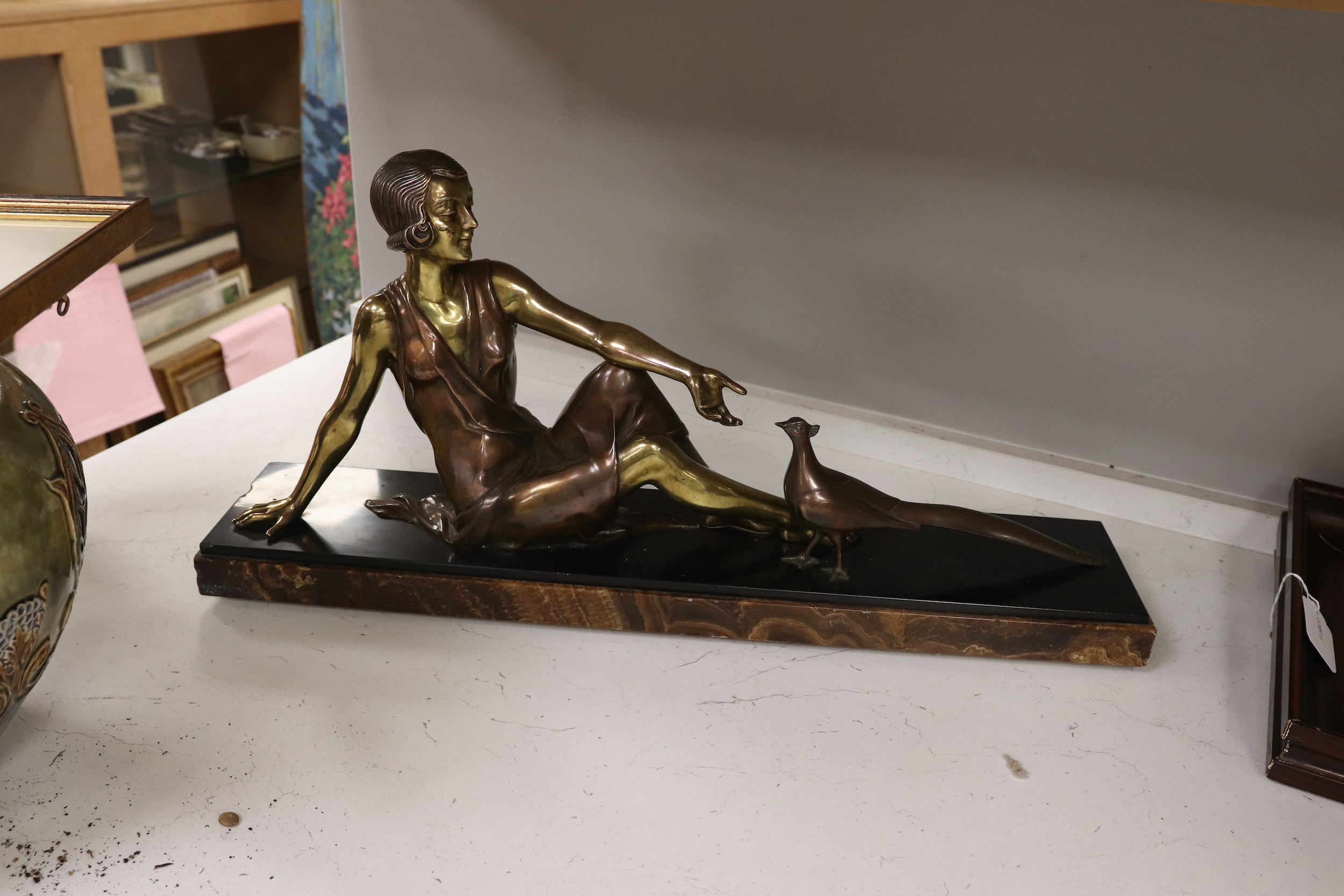 An Art Deco figural bronze of a girl with a peacock, VRAI Bronze foundry mark, signed Godard, on a marble base, base 65cm long, 30cm high. Condition - fair to good